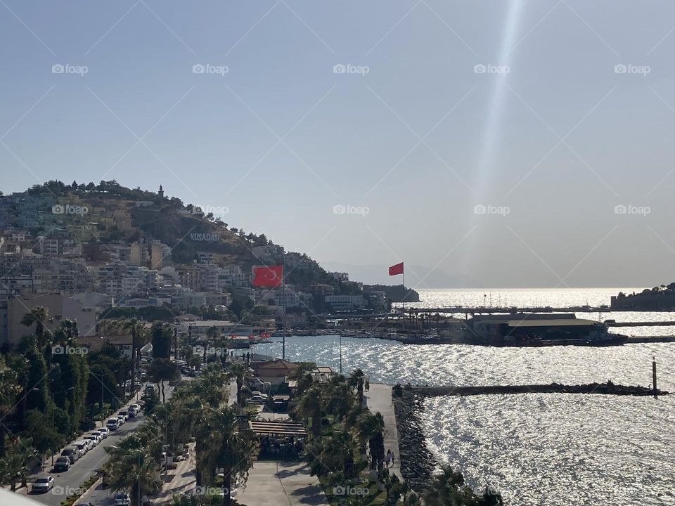 Beach time on holidays. Blue sky and tall palm trees. Sunsets and sunny days. Summertime in Kusadasi. Vacation travel in Turkey . Summer view. Sunny day during vacation 