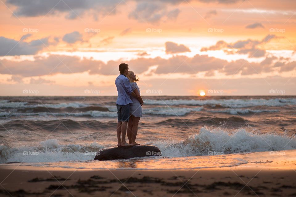 Romantic couple on the beach at sunset