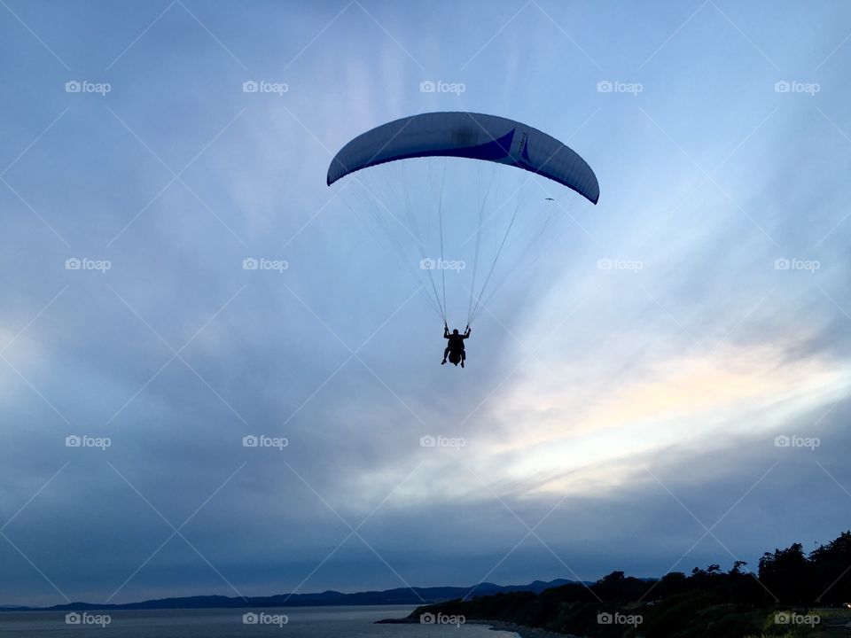 Paraglide flying over sea