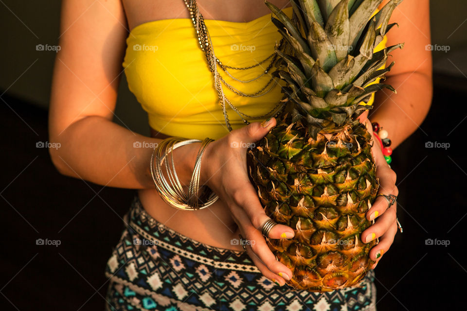 Woman holding pineapple