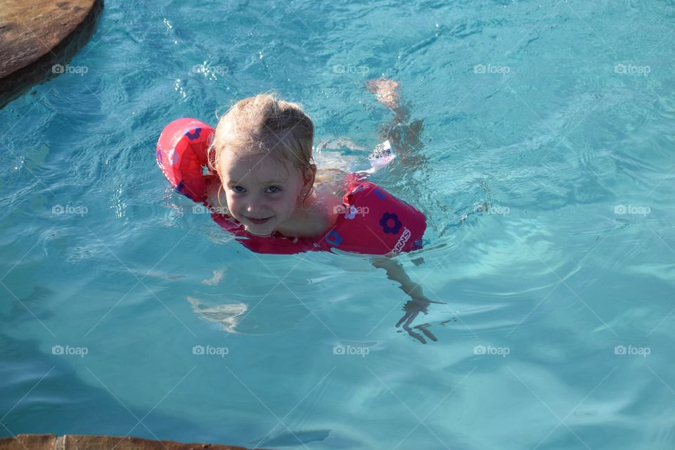 Little girl swimming in a pool