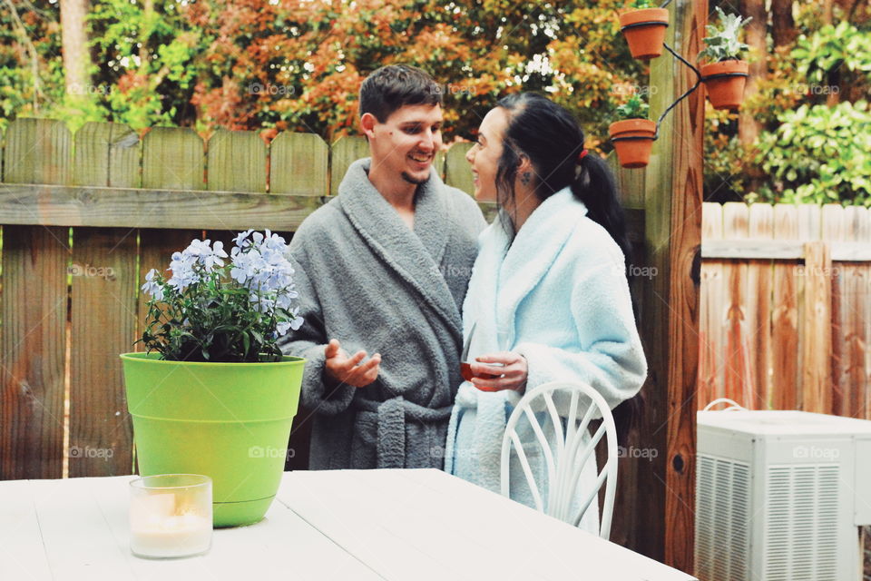 couple in robes laughing