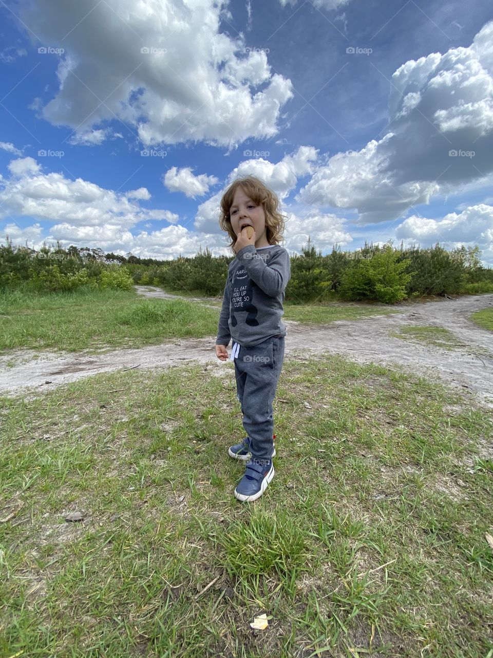 Little boy standing on the grass 