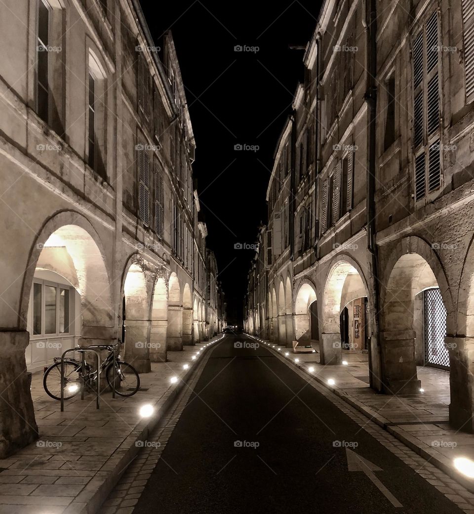 One bicycle in deserted street by night