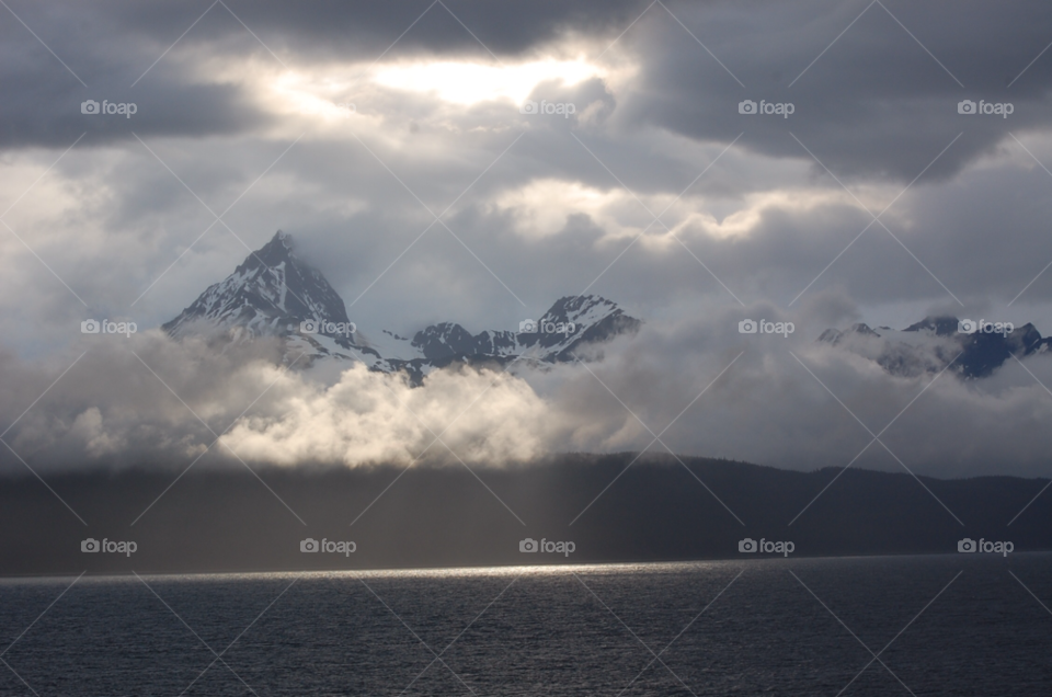 ocean mountain clouds sunlight by cwassi