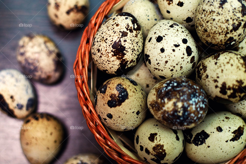 Close-up of quail eggs in basket