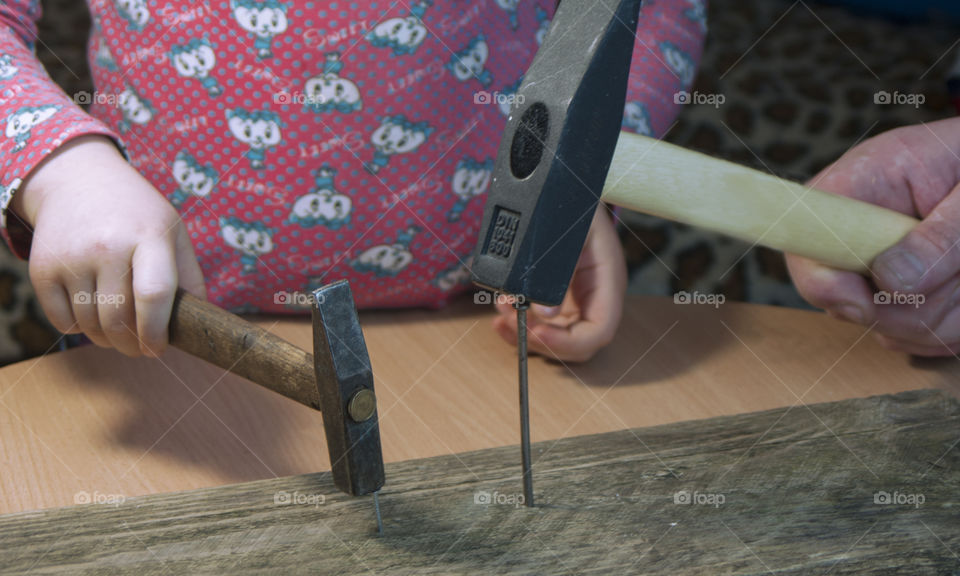 little girl holding tools