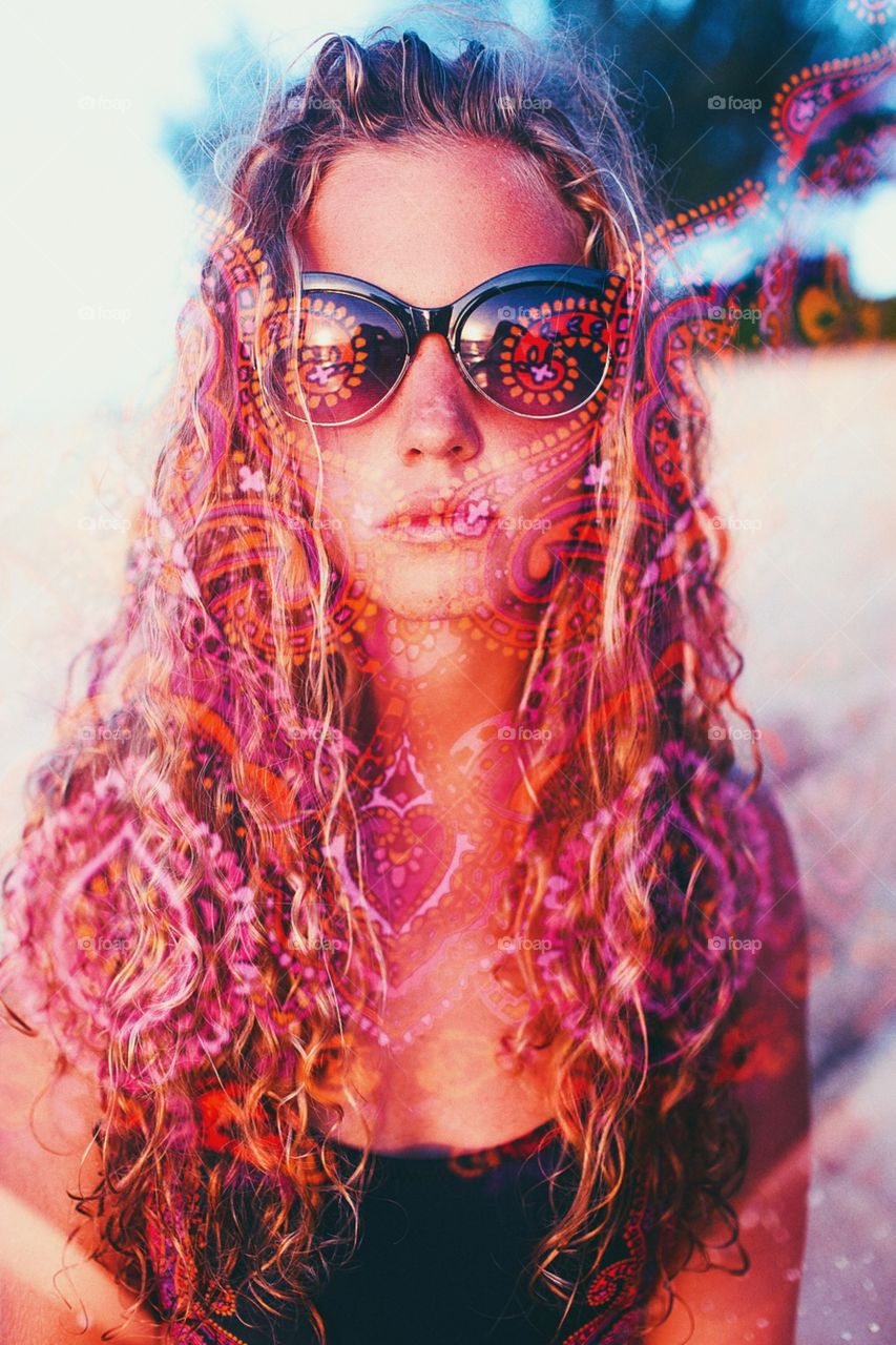 Groovy girl with sunglasses in psychedelic double exposure.
