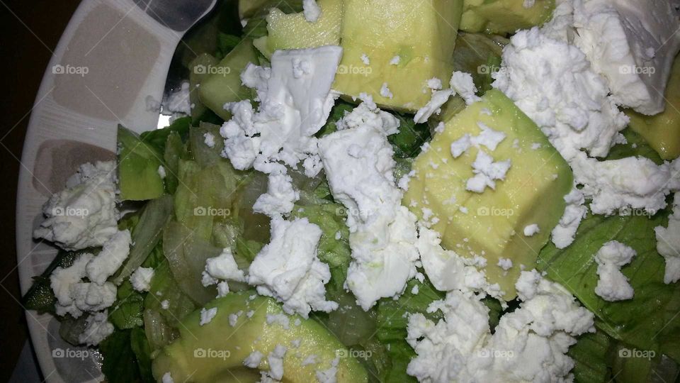 Close-up of salad with avocado, feta cheese and lettuce