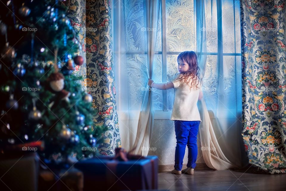 Little girl waiting the Santa at Christmas Eve 
