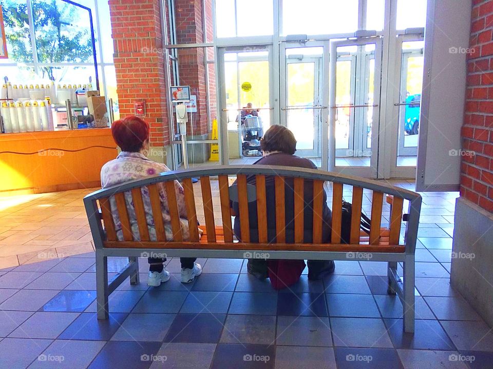 Elders resting on a bench 