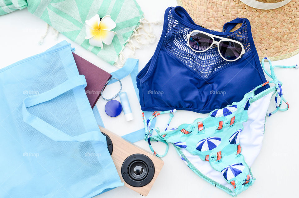 Blue theme flat lay of summer vacation items 