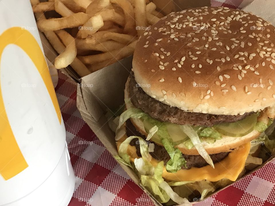 McDonald’s Big Mac, fries and drink on a red a white checkered background 