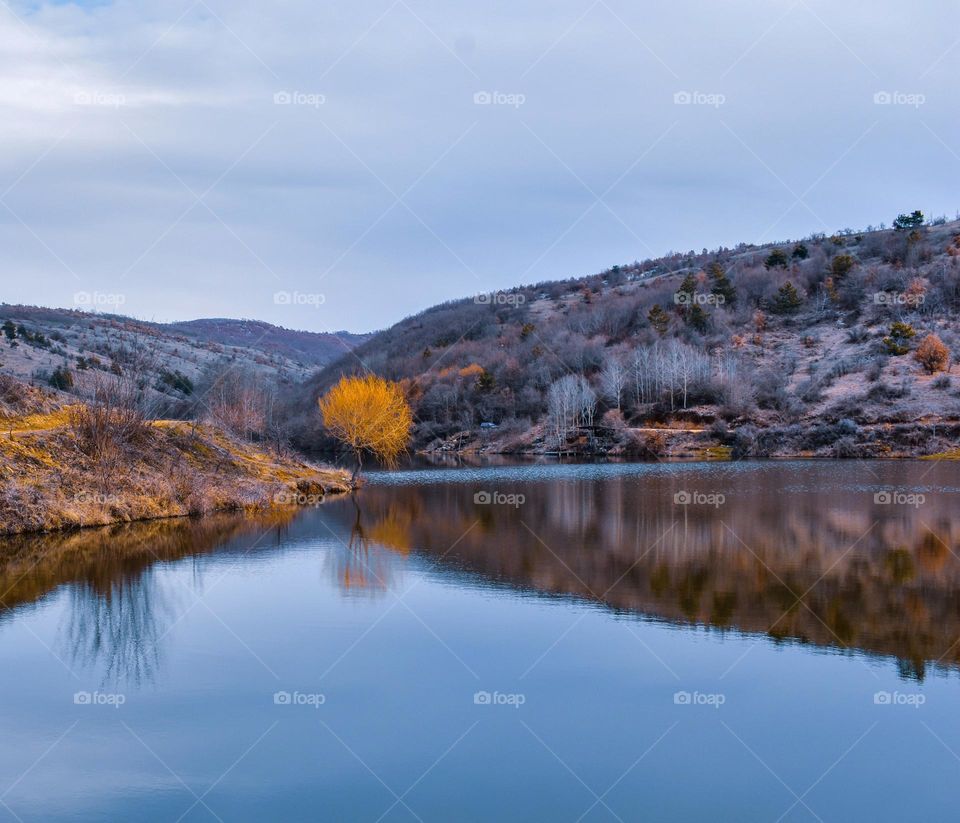 Autumn colors in the lake beside a mountains