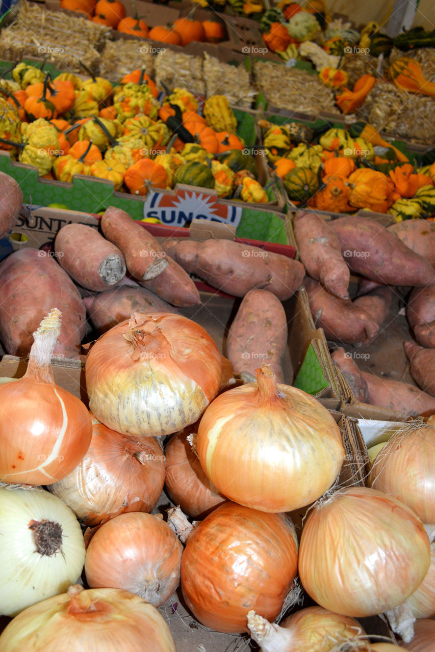 Onions and sweet potatoes at farmers market. 