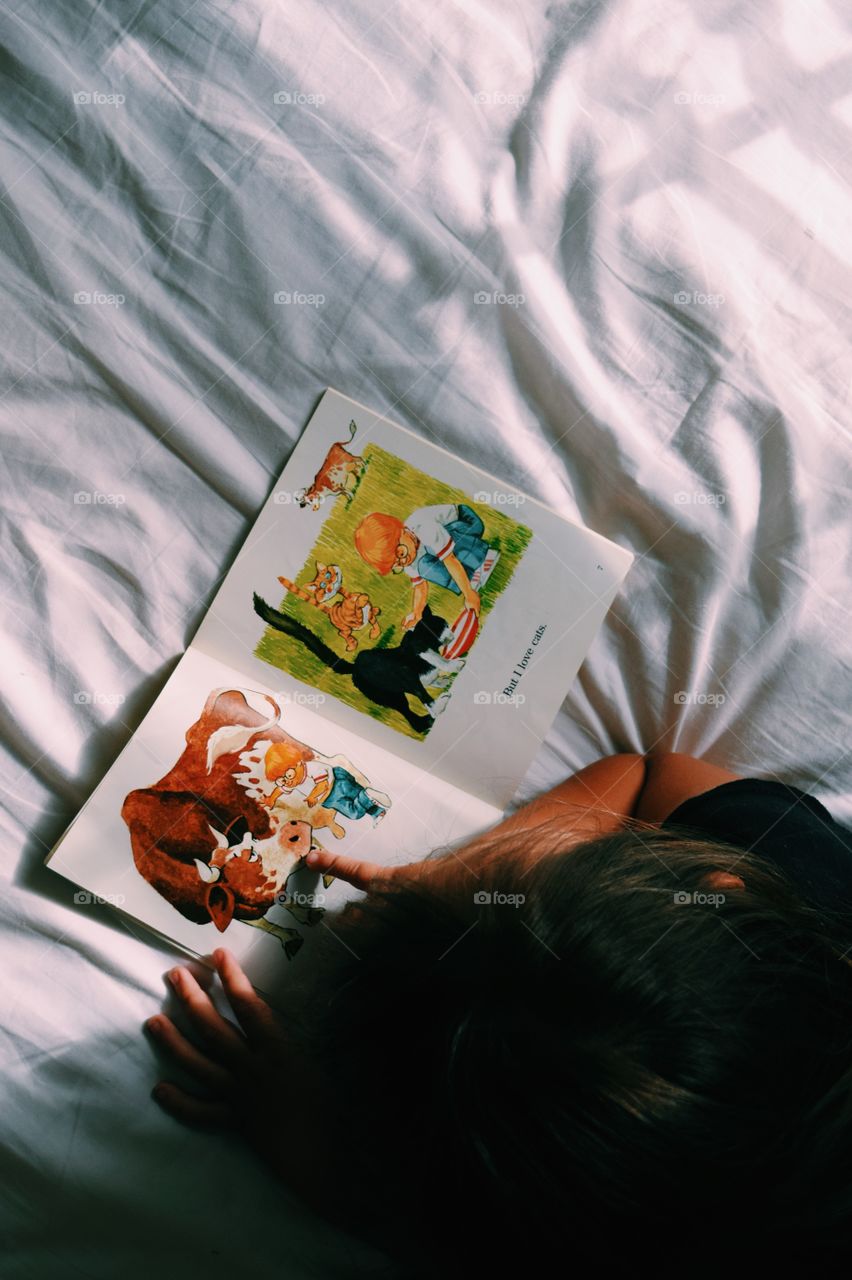 High angle view of a child reading story book