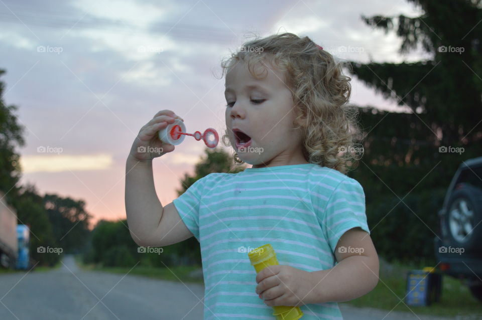 Girl trying to makes bubbles