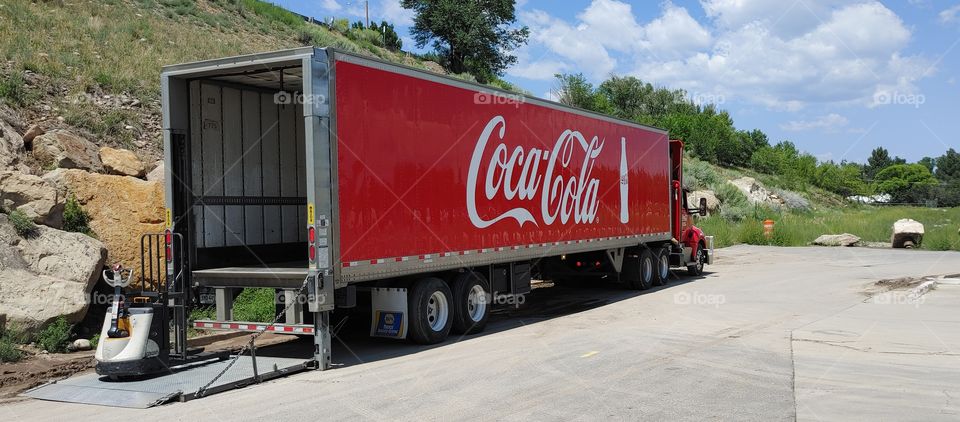 Coca-Cola truck unloaded at store