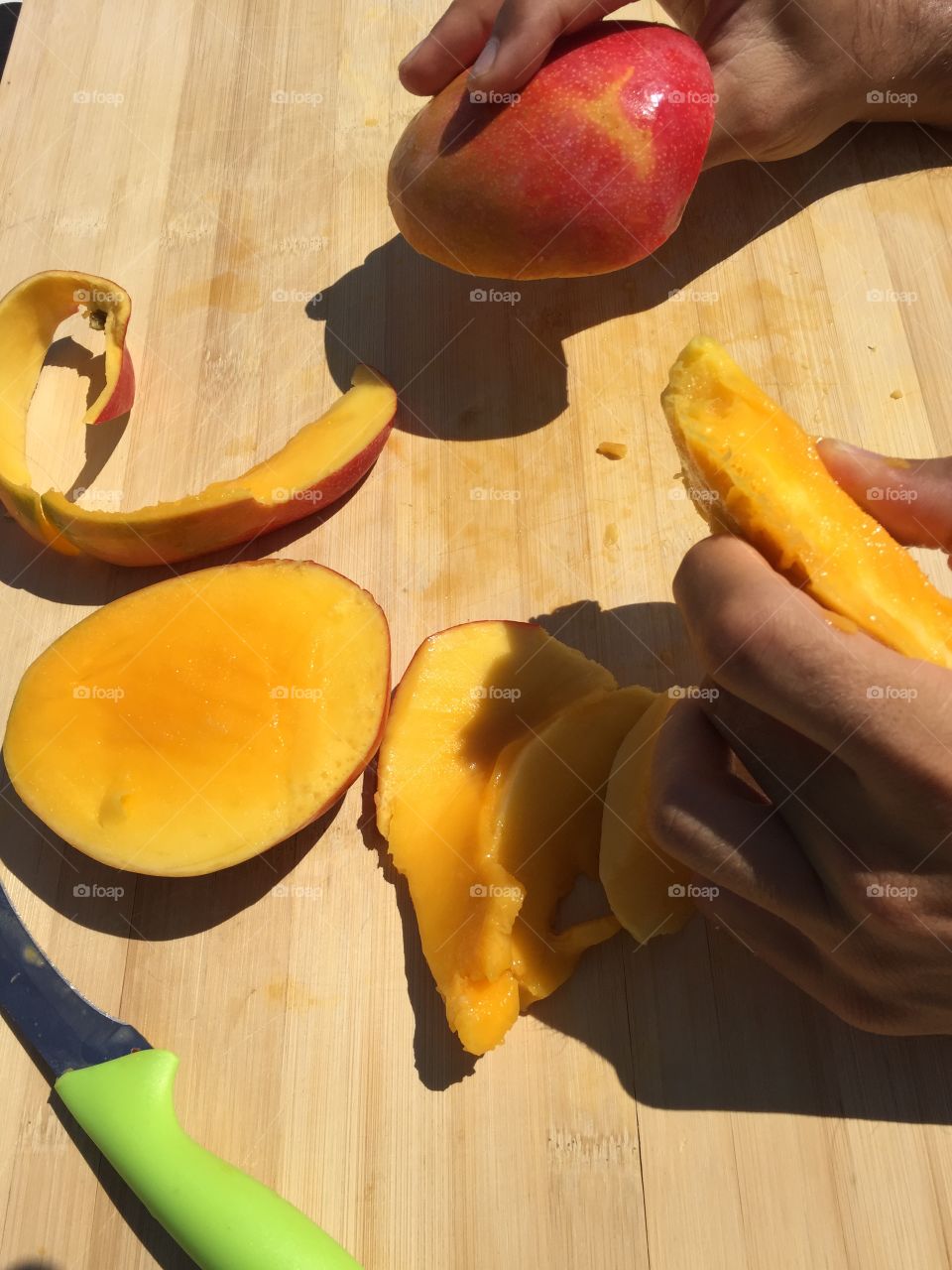 Cutting and eating Mango. Cutting and eating Mango under a hot Sun 