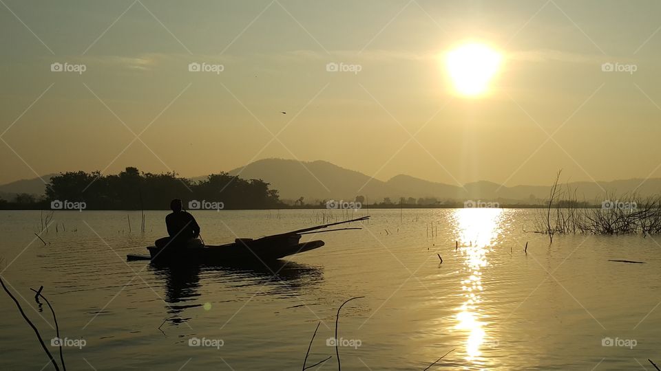 The fisherman in the sunrise lake