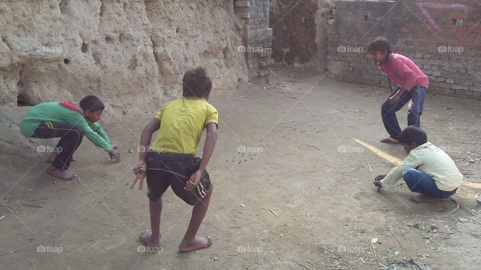children playing marble ball local game
