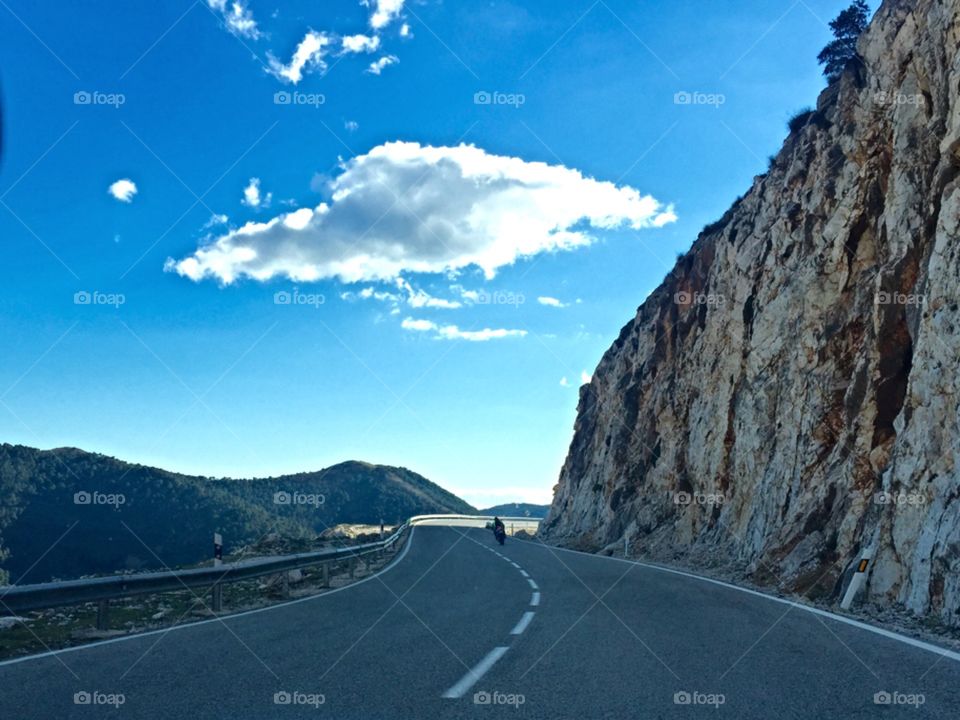 Scenic view of highway near rocky mountain