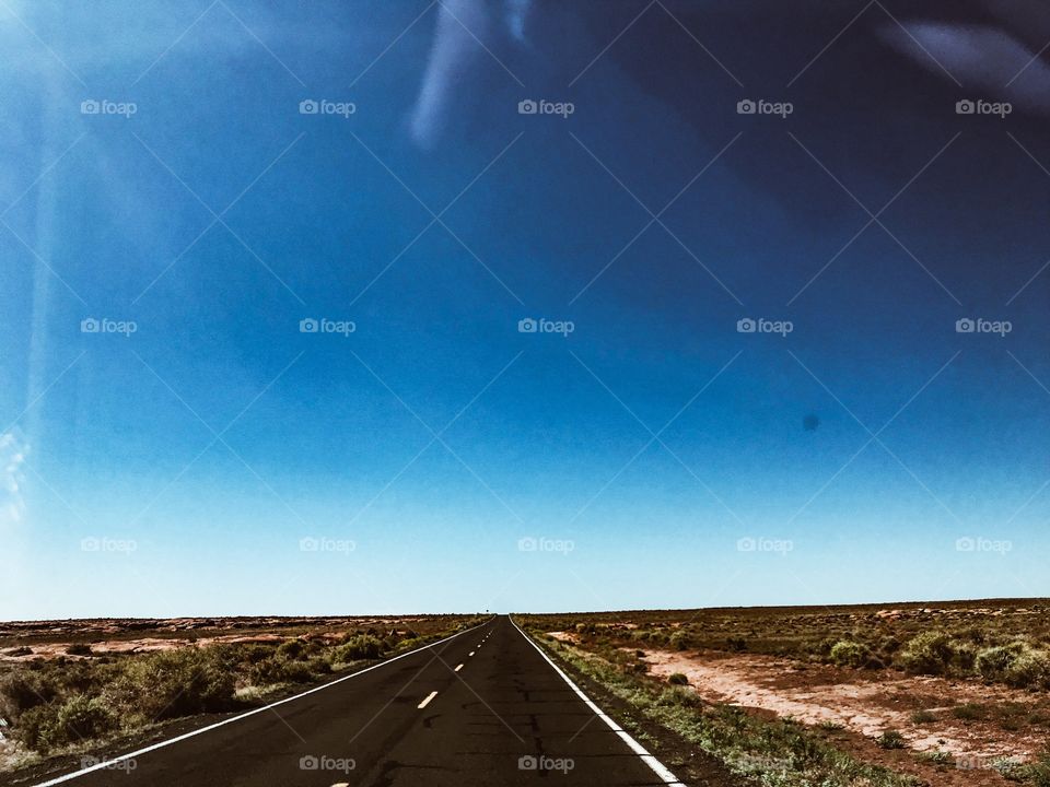 Wide open road in Arizona with cloudless sky