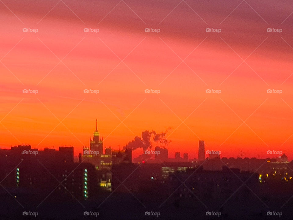 Russia Moscow.  City landscape.  Winter evening with red-orange sky, sunset over the roofs of houses