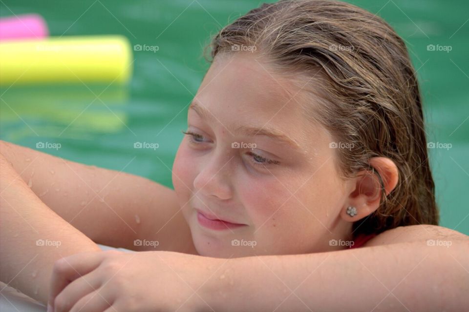 Smiling girl enjoying in pool