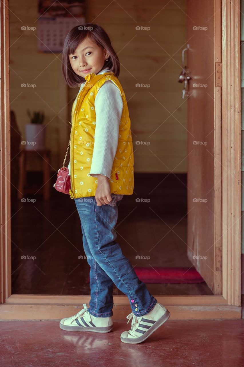 Inspired by the 80's colored photography,  portrait of a little girl in casual fashion clothing.