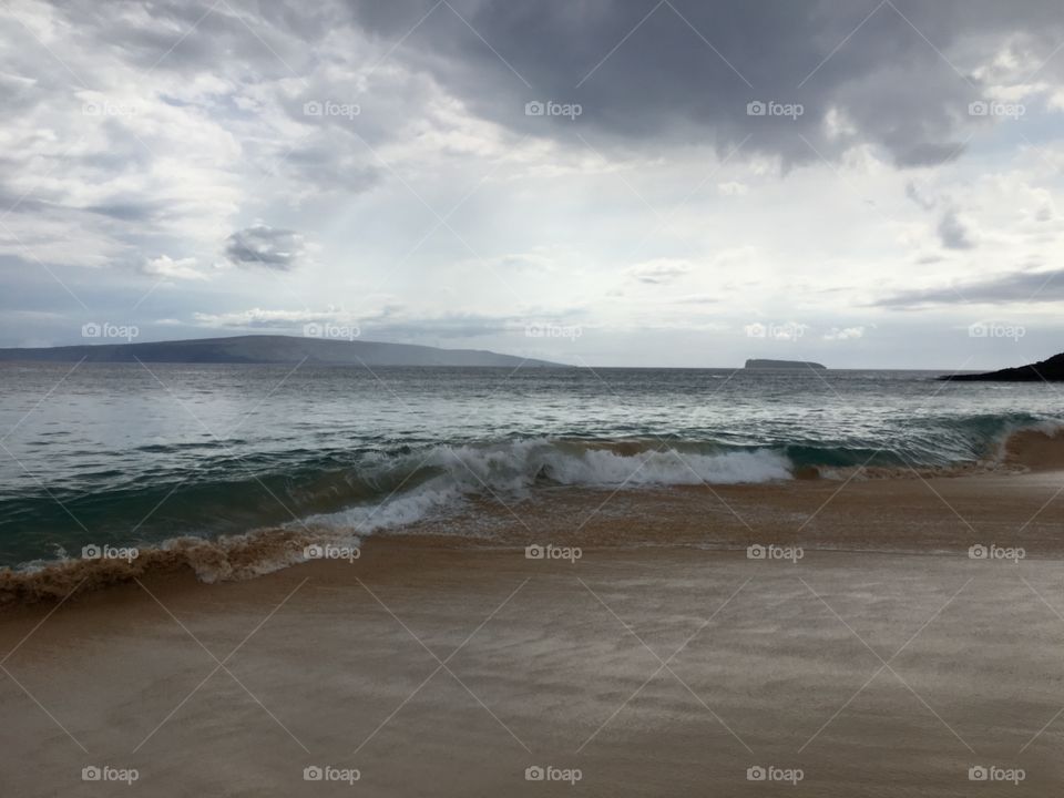 Scenic view of sea against cloudy sky