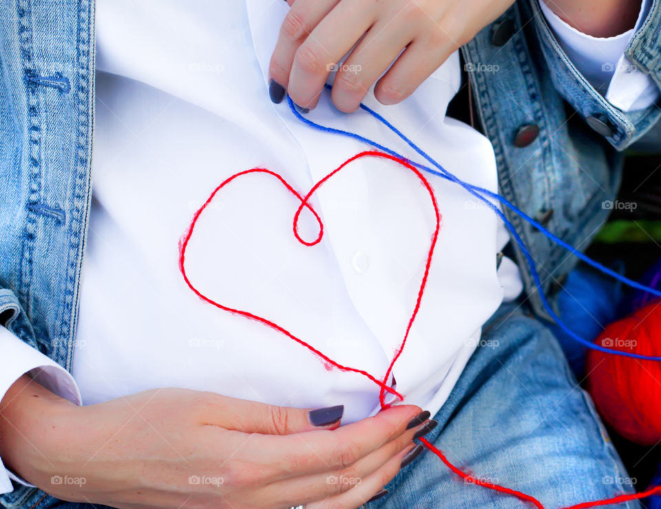 Pregnant women forming heart shape