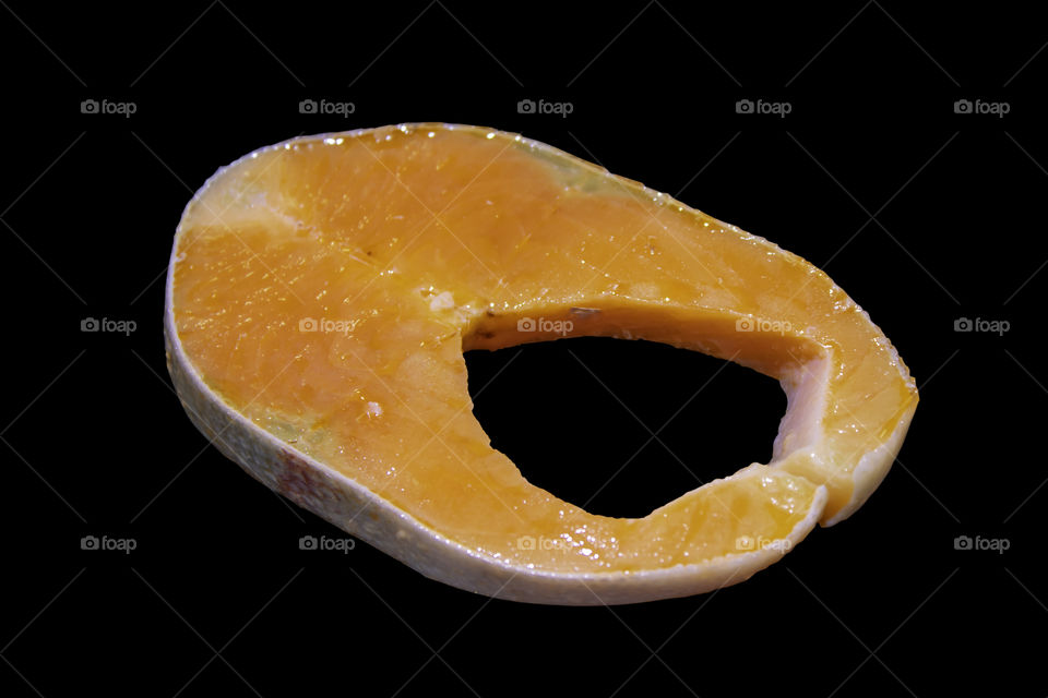 Isolated  Slice of Raw Salmon on a Black background with clipping path.