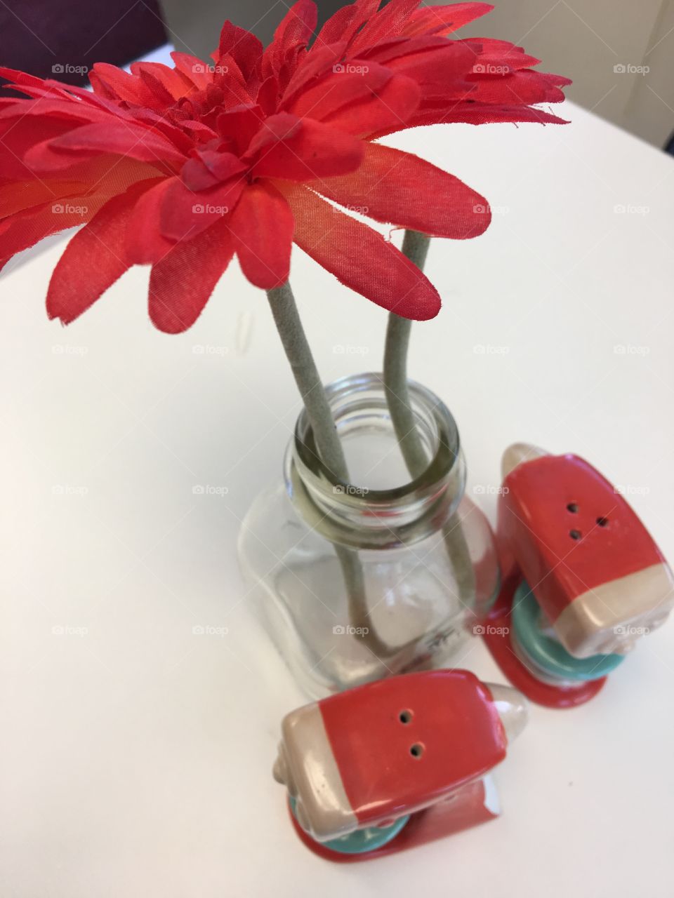 Flower next to Salt and Pepper Shakers