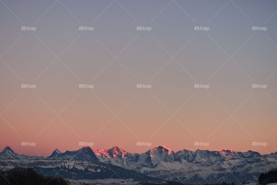 Peaks of Mountain range (eiger, mönch & jungfrau) lit by evening sun.