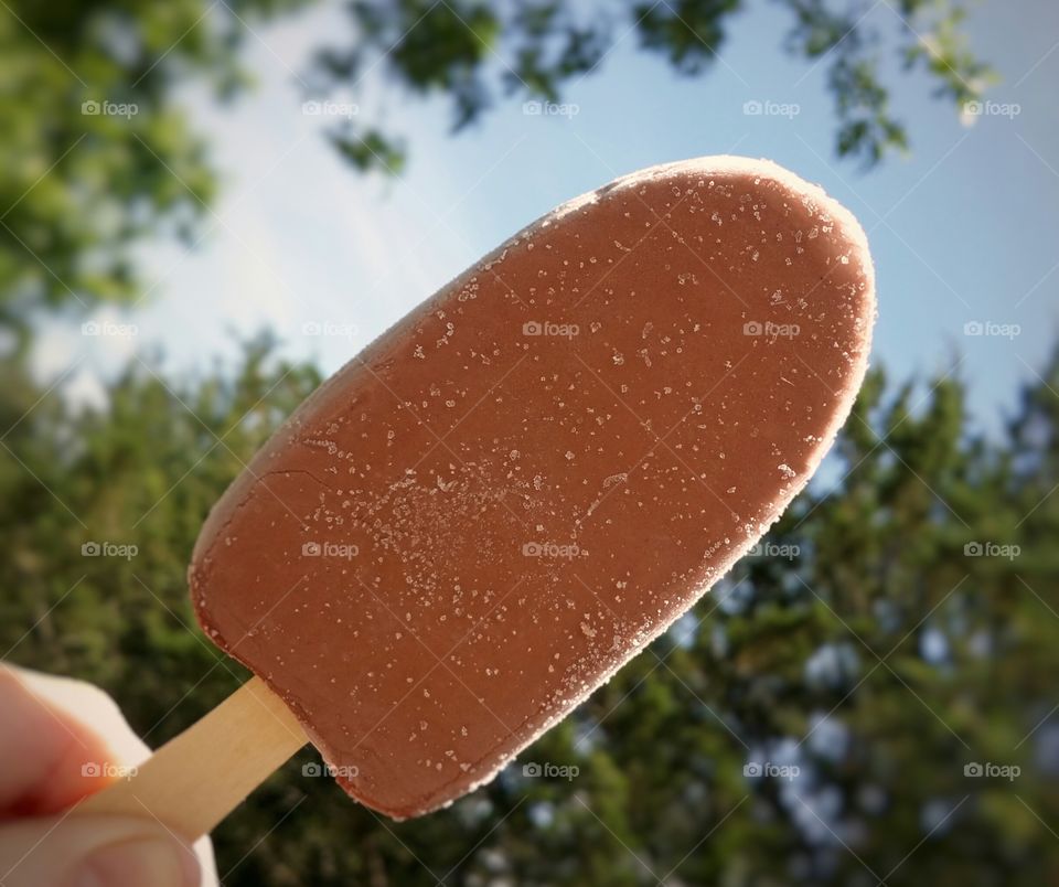 Person's hand holding ice cream