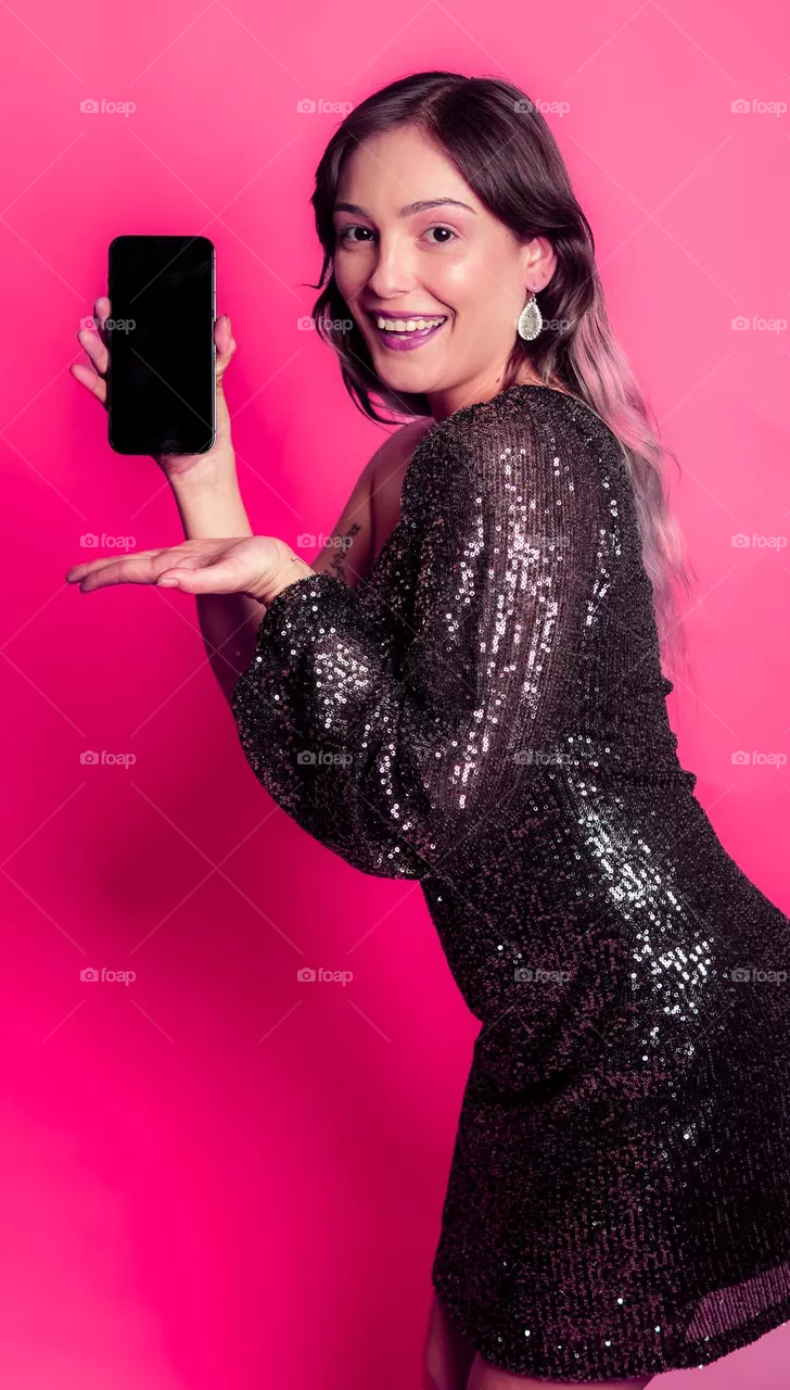 Beautiful Girl Holding a Phone for advertisement as a stock photo with background