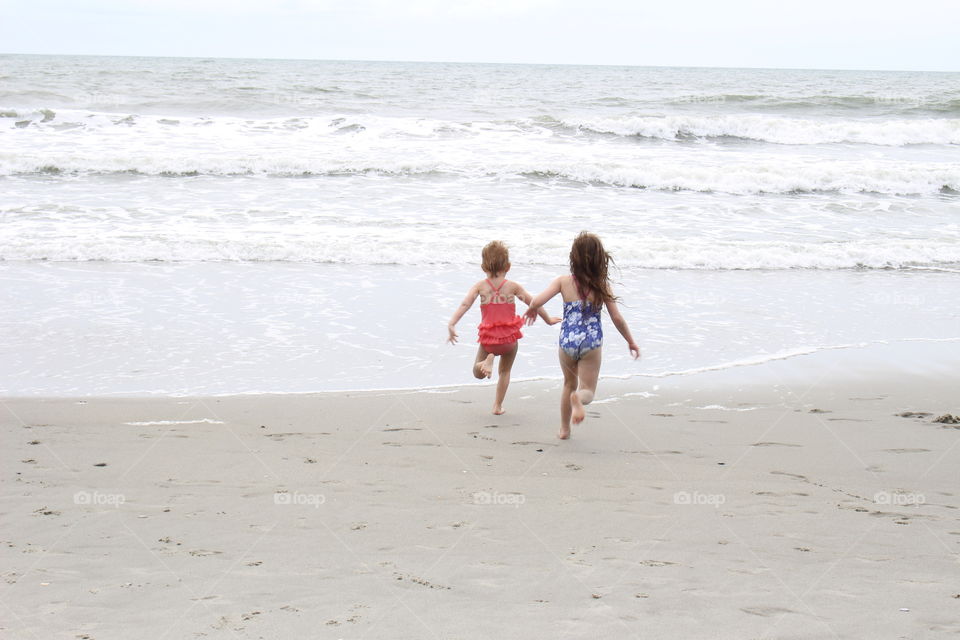 Girls running at the beach