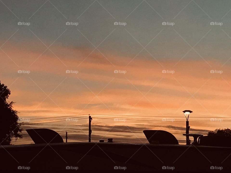 Following the Crack Of Dawn the morning sky receiving the suns glow. Clouds receiving the colors getting brighter as Sunrise gets Closer.