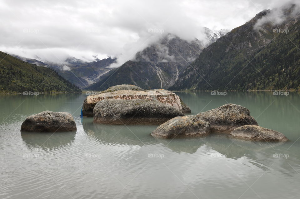 mysterious stones in a mountain lake