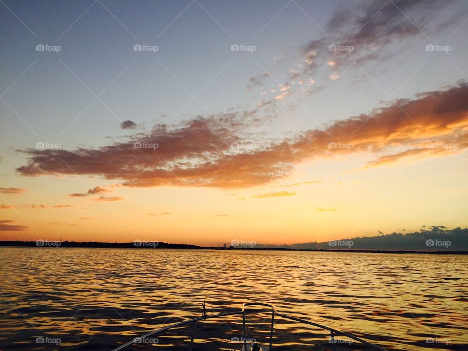 Subset sunrise on a boat in the ocean beautiful orange color 