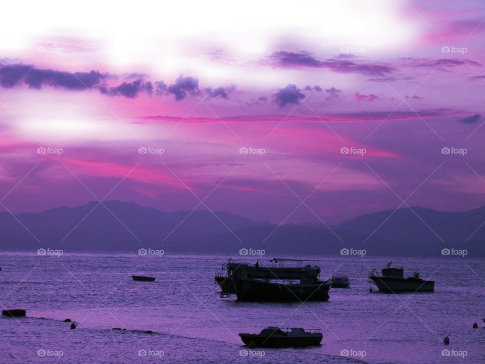 Magical Pink sunset with beautiful clouds over the beach of Praia ( Italy ).