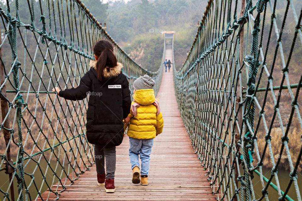 Girls on wooden suspension bridge