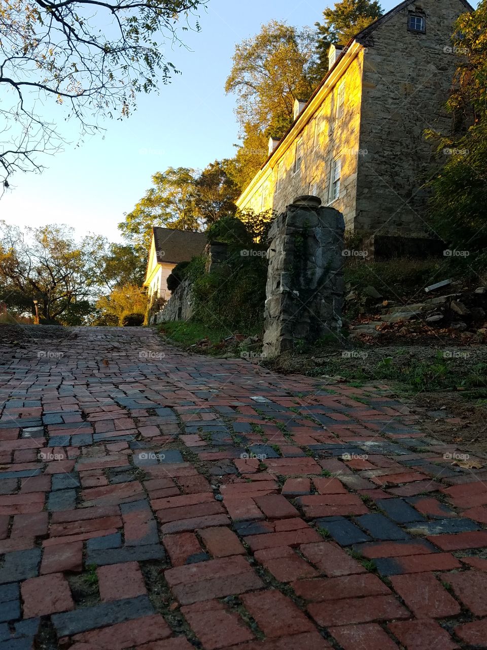 Brick driveway in front of mansion