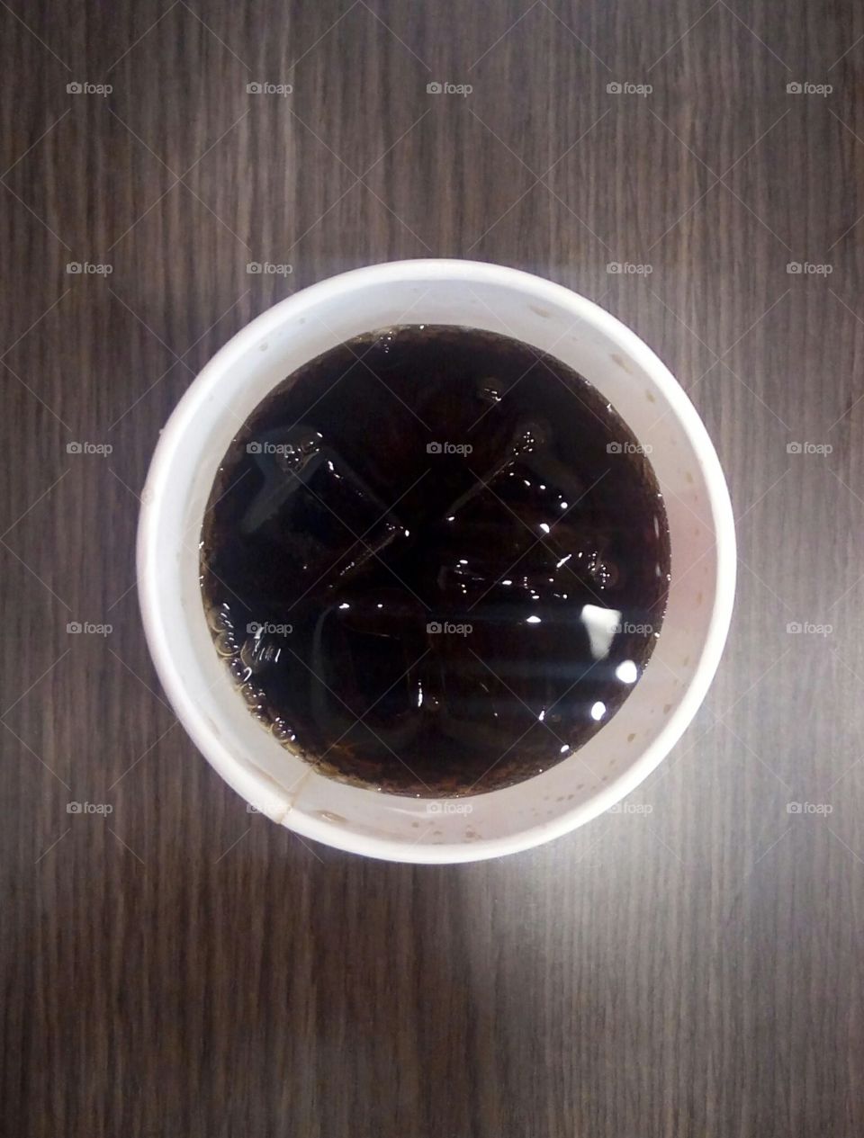 glass with soda and ice drink seen from above