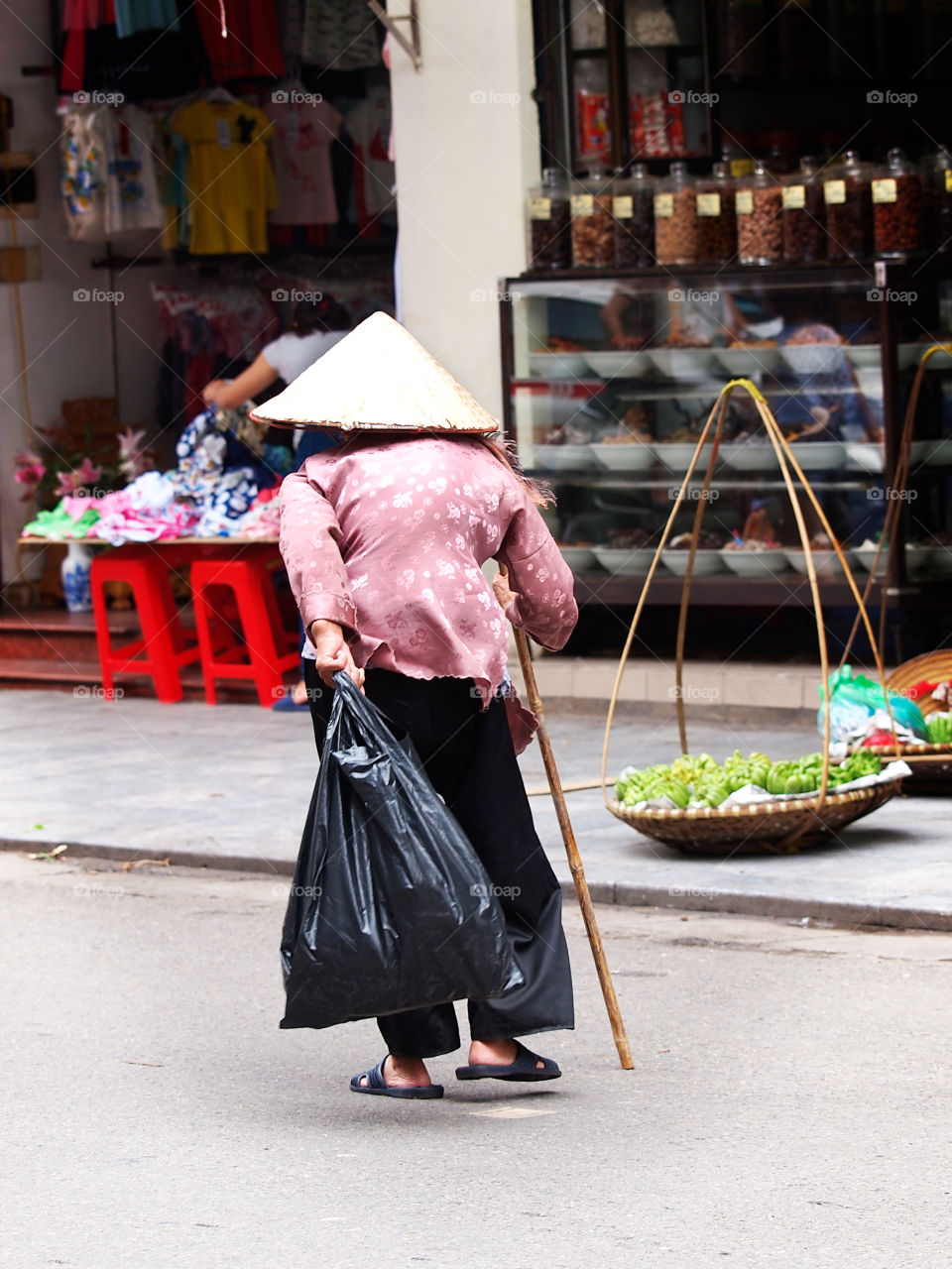 A very old woman in Hanoi streets