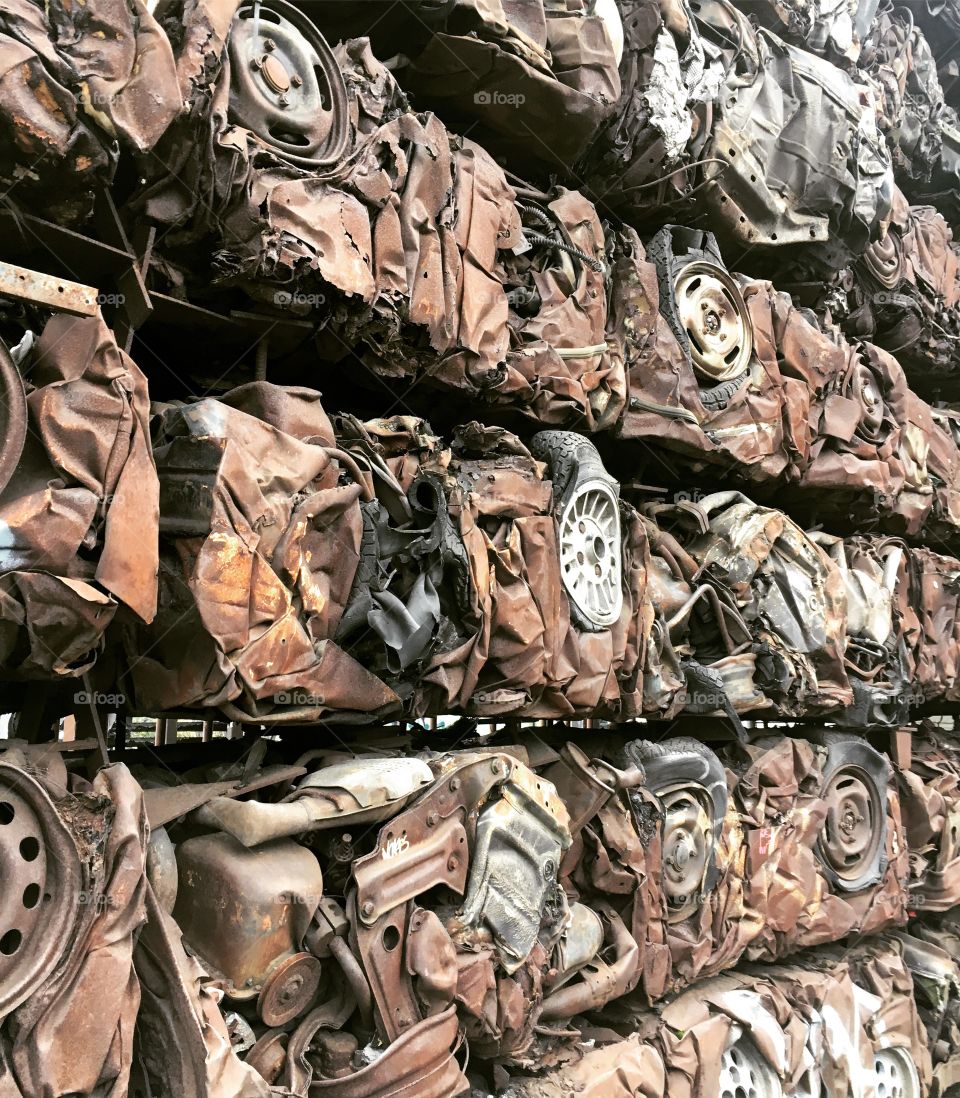 Wall made out of crushed cars, rusty 