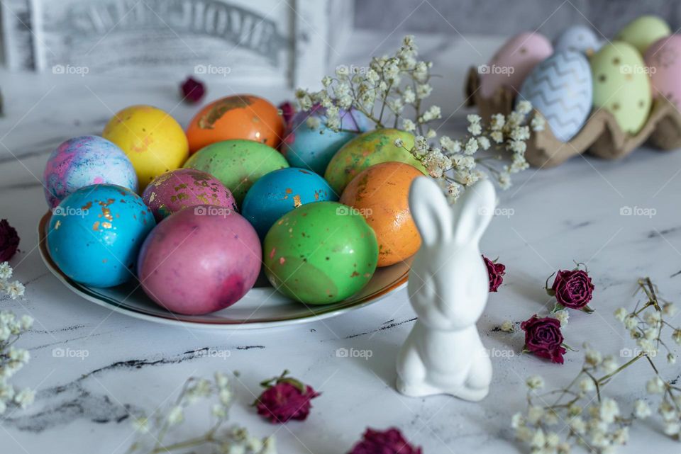 Easter compositions Color eggs and white banny rabbit 