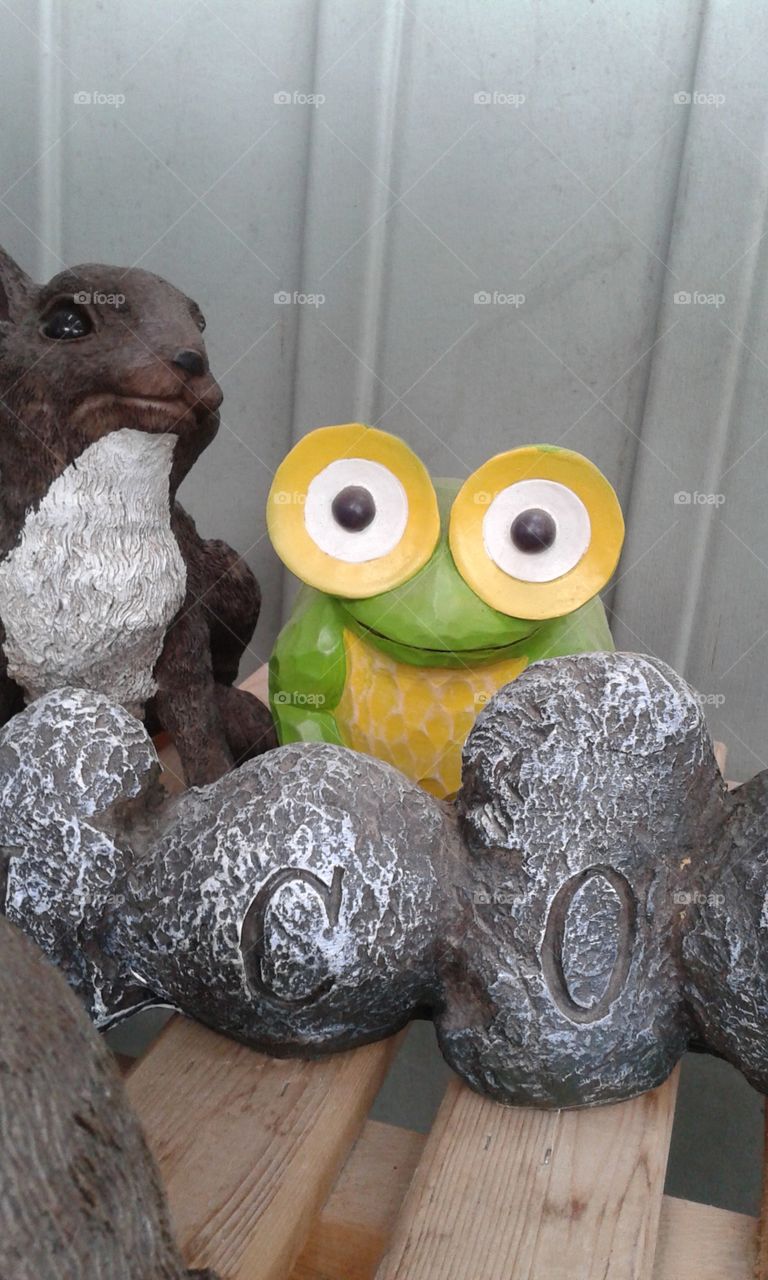 Look out!!.  A staring frog amongst other garden decor. 