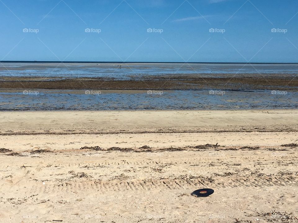 Single vinyl music record on beach surf at low tide tropical beach scene rock and roll